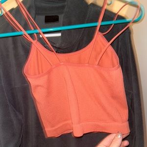 So cute very fitting orange tank with cute design straps.